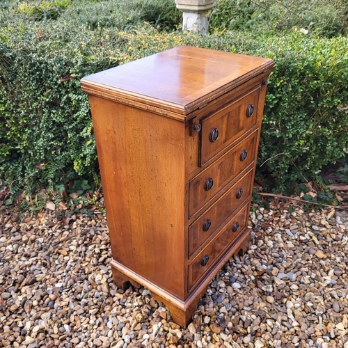 355 - A REGENCY STYLE YEW PEDESTAL CHEST
The fold over top with green tooled leather writing surface above... 