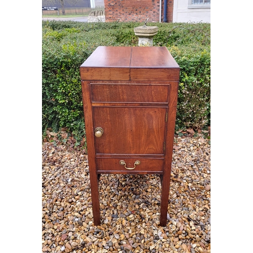 357 - A GEORGIAN MAHOGANY GENTLEMAN'S WASHSTAND
The fold over top enclosing a fitted interior above cupboa... 