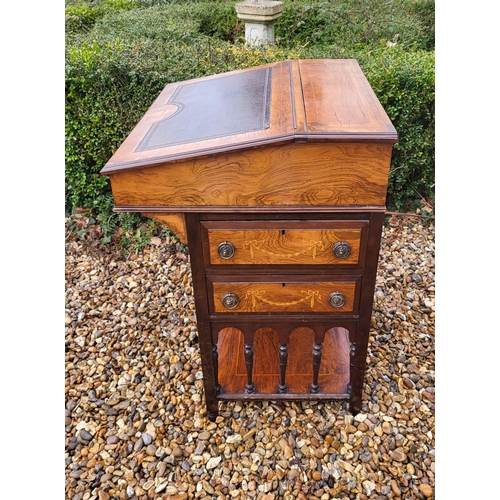 358 - A LATE VICTORIAN ROSEWOOD AND MARQUETRY INLAID DAVENPORT DESK
The rise and fall top enclosing and bi... 