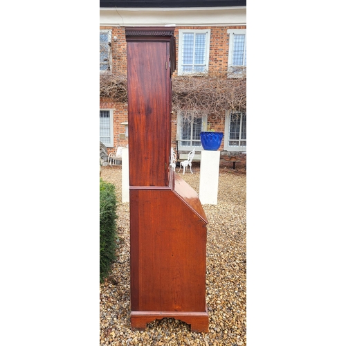 361 - AN 18TH CENTURY SOLID MAHOGANY NEO CLASSICAL BUREAU BOOKCASE 
With architectural pediment above two ... 