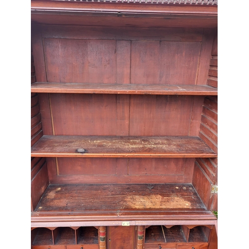 361 - AN 18TH CENTURY SOLID MAHOGANY NEO CLASSICAL BUREAU BOOKCASE 
With architectural pediment above two ... 