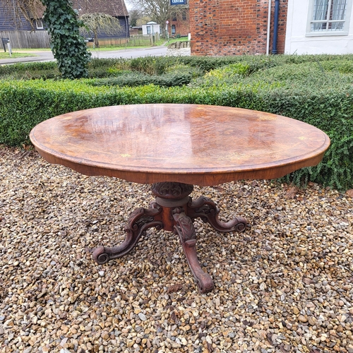 362 - A VICTORIAN BURR WALNUT LOO TABLE
The oval top supported on a carved bulbous column with four splaye... 