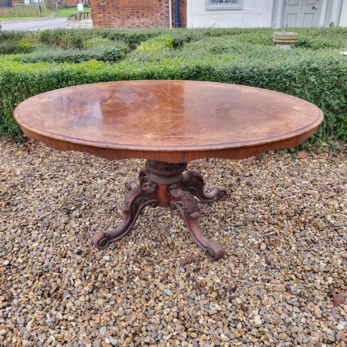 362 - A VICTORIAN BURR WALNUT LOO TABLE
The oval top supported on a carved bulbous column with four splaye... 