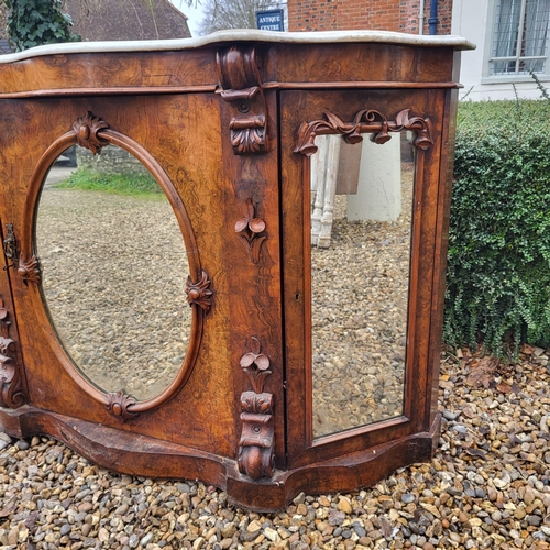 363 - A VICTORIAN BURR AND FIGURED WALNUT SIDE CABINET/CREDENZA 
With white marble serpentine top above an... 