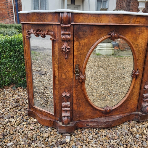 363 - A VICTORIAN BURR AND FIGURED WALNUT SIDE CABINET/CREDENZA 
With white marble serpentine top above an... 