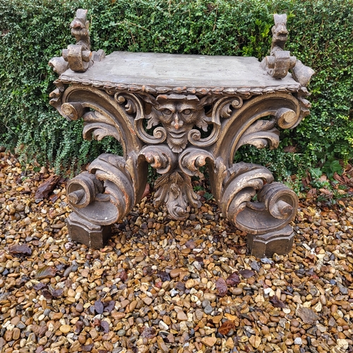 367 - AN 18TH/19TH CENTURY ITALIAN CARVED GILTWOOD LOW CONSOLE TABLE
With scrolling foliage legs centred w... 