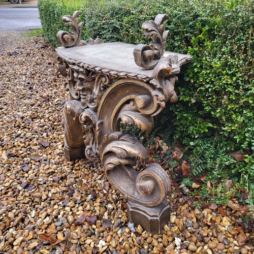 367 - AN 18TH/19TH CENTURY ITALIAN CARVED GILTWOOD LOW CONSOLE TABLE
With scrolling foliage legs centred w... 