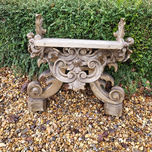 367 - AN 18TH/19TH CENTURY ITALIAN CARVED GILTWOOD LOW CONSOLE TABLE
With scrolling foliage legs centred w... 