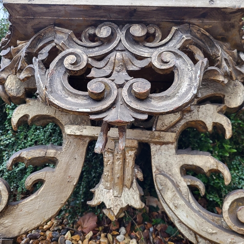 367 - AN 18TH/19TH CENTURY ITALIAN CARVED GILTWOOD LOW CONSOLE TABLE
With scrolling foliage legs centred w... 