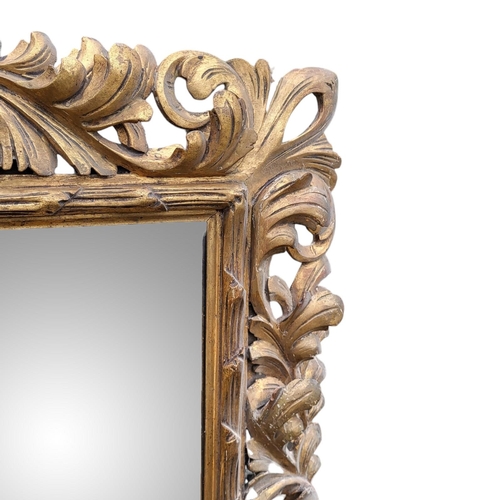 371 - A LARGE 19TH CENTURY ORGANIC CARVED GILT WOOD FRAMED MIRROR
With entwined leaves surrounding a silve... 