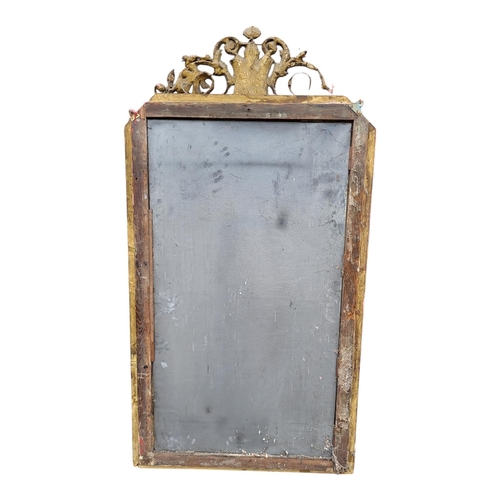 372 - A LARGE  EARLY 19TH CENTURY GILT FRAMED MIRROR
With floral cartouche above mercury plate with canted... 