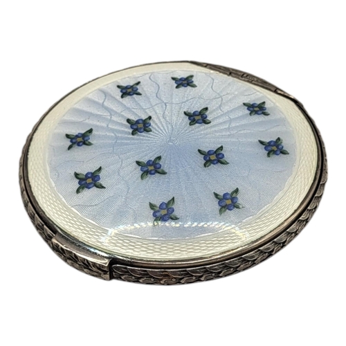 43 - A MID CENTURY SILVER AND ENAMEL POWDER COMPACT
Blue guilloché enamel with floral decoration, hallmar... 