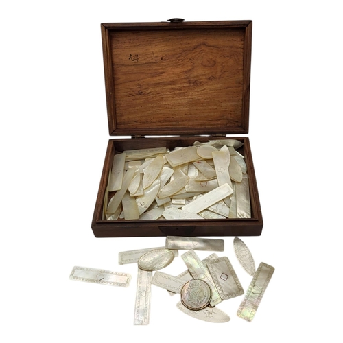 49 - A COLLECTION OF EARLY 20TH CENTURY CARVED MOTHER OF PEARL GAMING TOKENS
Including fish and lozenge s... 