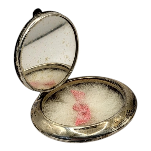 53 - AN EARLY 20TH CENTURY SILVER AND ENAMEL POWDER COMPACT
The lid set with yellow guilloche enamel, hal... 