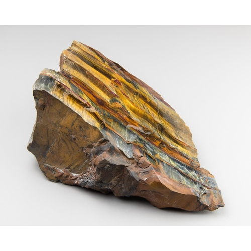 643 - A LARGE TIGERS EYE CRYSTAL SLICE.
Polished face with natural rough sides. (h 21.5cm x w 15cm x d 8cm... 