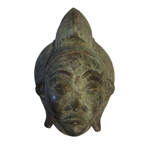 256 - AN AFRICAN BRONZE TRIBAL MASK
Engraved decoration and verdigris to surface.
(approx 39cm)

Condition... 