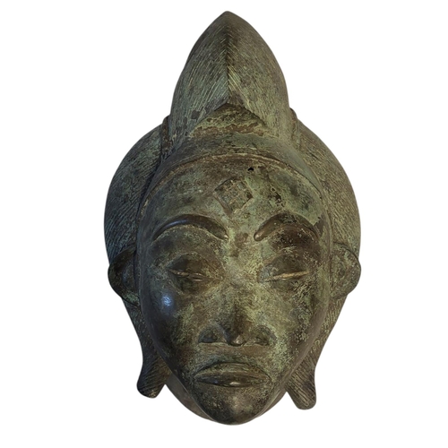 256 - AN AFRICAN BRONZE TRIBAL MASK
Engraved decoration and verdigris to surface.
(approx 39cm)

Condition... 