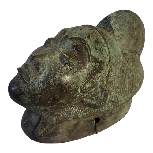 256 - AN AFRICAN BRONZE TRIBAL MASK
Engraved decoration and verdigris to surface.
(approx 39cm)

Condition... 