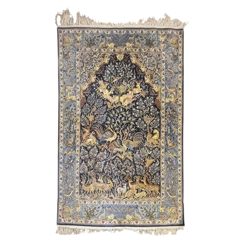 267 - A VINTAGE PERSIAN SILK ‘SHAHREZA TREE OF LIFE ‘ RUG
The central arched field woven with animals and ... 