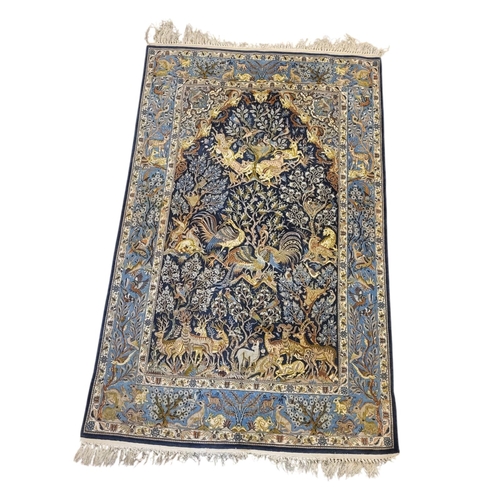 267 - A VINTAGE PERSIAN SILK ‘SHAHREZA TREE OF LIFE ‘ RUG
The central arched field woven with animals and ... 