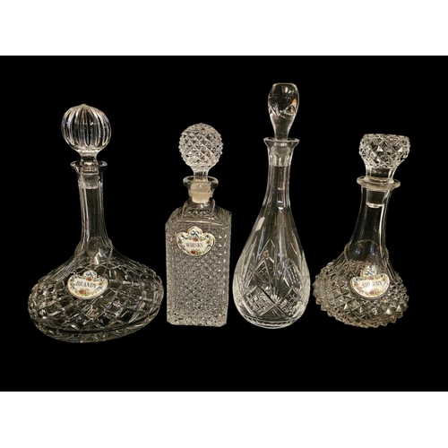 279 - A COLLECTION OF FOUR CUT LEAD CRYSTAL GLASS DECANTERS
To include a ship’s decanter, an Edinburgh cry... 