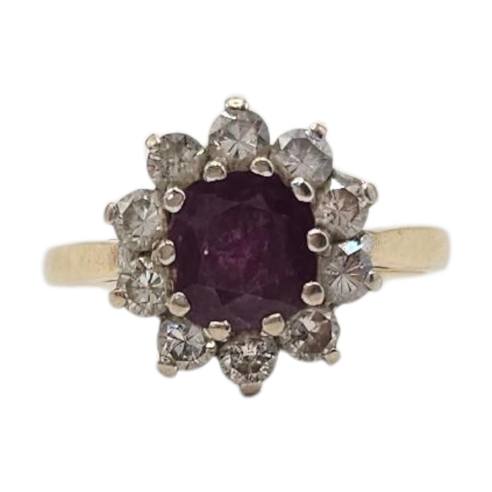 A VINTAGE 18CT GOLD RUBY AND NATURAL DIAMOND RING The central oval cut ...