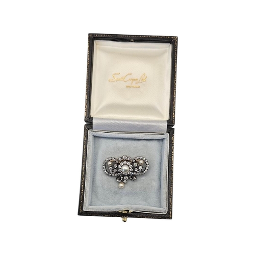 12 - A LATE VICTORIAN/EDWARDIAN YELLOW METAL NATURAL PEARL AND DIAMOND SCROLL BROOCH
The openwork foliate... 