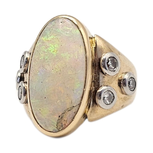 18A - A VINTAGE 18CT GOLD OPAL AND DIAMOND RING
The central oval cut opal flanked with round cut diamonds.... 