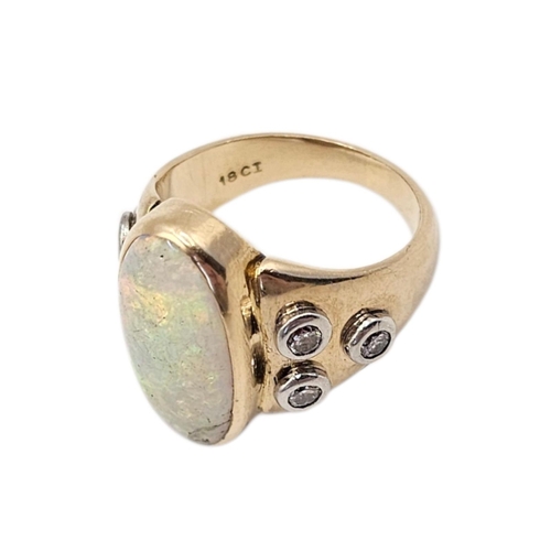 18A - A VINTAGE 18CT GOLD OPAL AND DIAMOND RING
The central oval cut opal flanked with round cut diamonds.... 