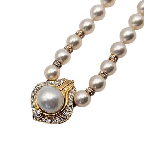 29A - AN 18CT GOLD, DIAMOND AND MABE PEARL AND DIAMOND NECKLACE
A cultured pearl necklace centering  an 18... 