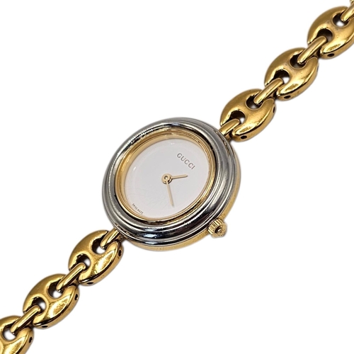 8A - GUCCI, A VINTAGE GOLD PLATED MARINER LINK LADIES’ WRISTWATCH
The circular white dial with gilt hands... 