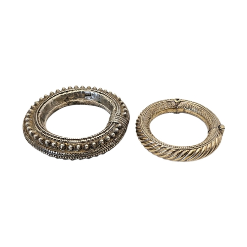 6 - TWO 19TH CENTURY TRIBAL WHITE METAL OMANI BANGLES
To include a hinged bangle with rope twist design ... 