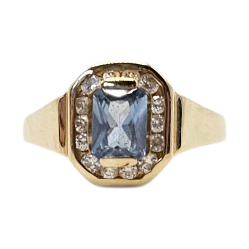 3A - A VINTAGE YELLOW METAL AQUAMARINE AND DIAMOND RING 
The central rectangular cut aqua stone edged wit... 