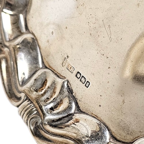 10A - A VICTORIAN SILVER SALVER
Having a shell and scroll border and three bun feet, hallmarked Sheffield,... 