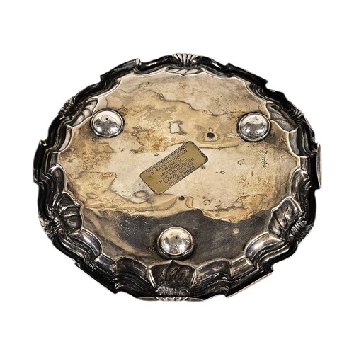 10A - A VICTORIAN SILVER SALVER
Having a shell and scroll border and three bun feet, hallmarked Sheffield,... 