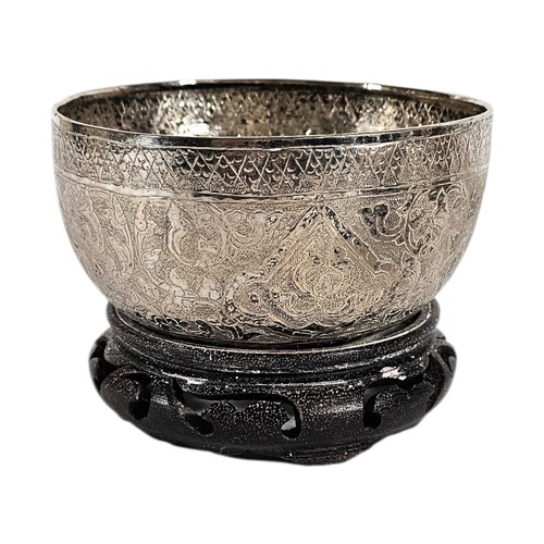 17A - AN EARLY 20TH CENTURY BURMESE SILVER BUDDHIST SINGING BOWL
Having fine engraved decoration, on hardw... 