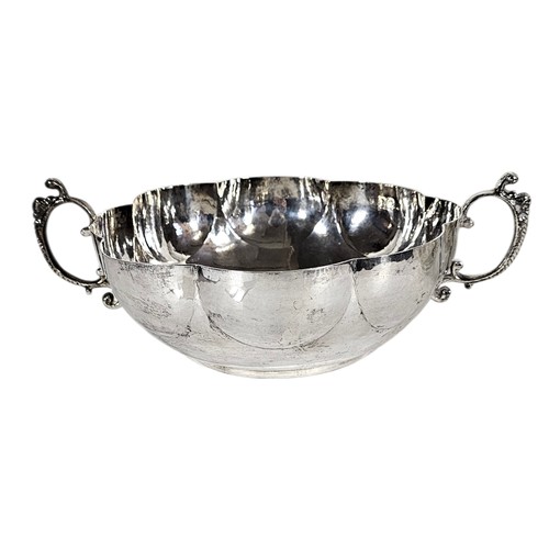 32A - A PAIR OF LARGE 17TH CENTURY SILVER CIRCULAR BOWLS
Having cast side handles, lobed borders and plani... 