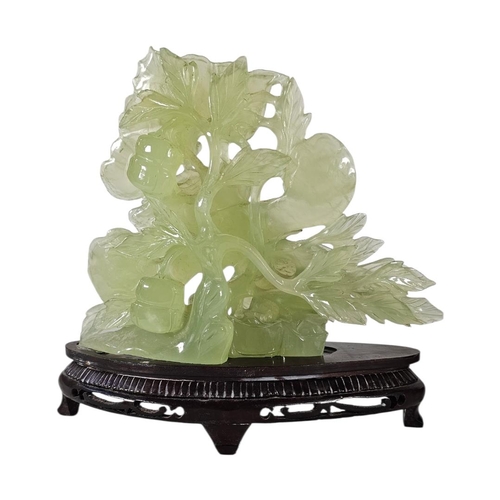 214 - A CHINESE CARVED CELADON HARDSTONE GROUP
Likely bowenite, the large scale pierced work depicting a c... 