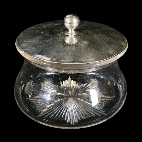 33 - A LARGE EDWARDIAN SILVER AND CUT GLASS BISCUIT BOX
Circular form with engine turned decoration and c... 