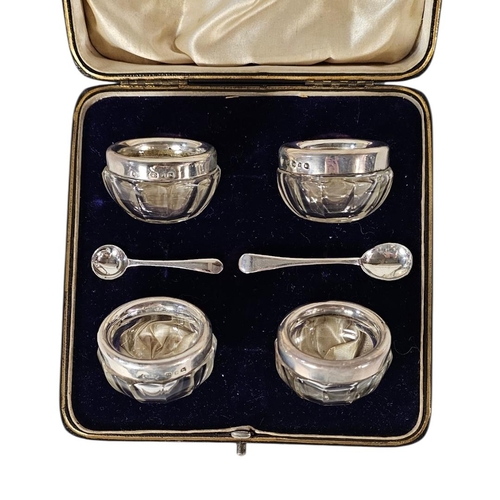 34 - A SET OF FOUR VICTORIAN SILVER AND GLASS SALTS
Each set with a silver rim hallmarked Joseph Rodgers,... 
