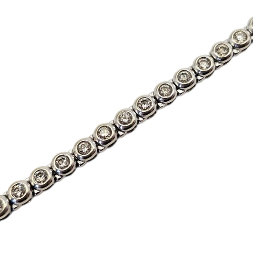36 - A 9CT WHITE GOLD AND DIAMOND TENNIS BRACELET
Having a row of round cut diamonds.
(approx total diamo... 
