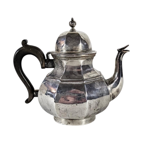 79 - AN EARLY 20TH CENTURY SILVER TEAPOT
Octagonal form, with turned wooden handle, hallmarked London, 19... 