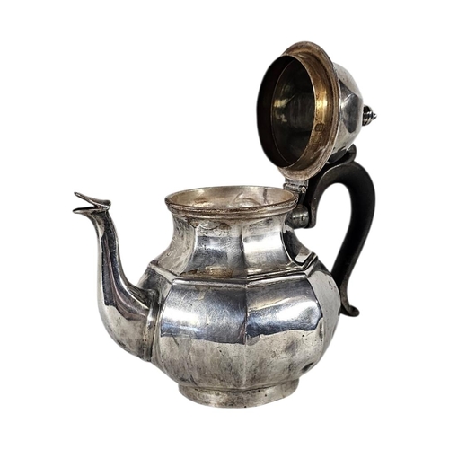 79 - AN EARLY 20TH CENTURY SILVER TEAPOT
Octagonal form, with turned wooden handle, hallmarked London, 19... 