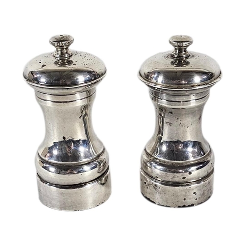 89 - A PAIR OF 20TH CENTURY SILVER PEPPER MILLS
Plain form, with reading base marked ‘Peter Piper’, hallm... 