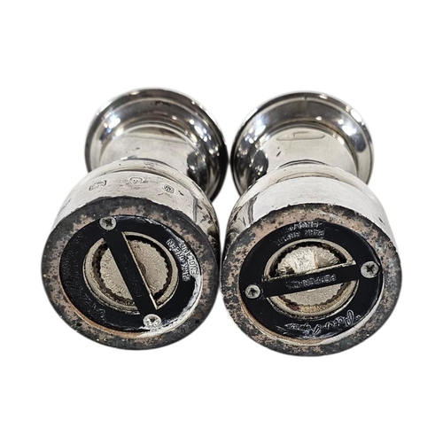 89 - A PAIR OF 20TH CENTURY SILVER PEPPER MILLS
Plain form, with reading base marked ‘Peter Piper’, hallm... 