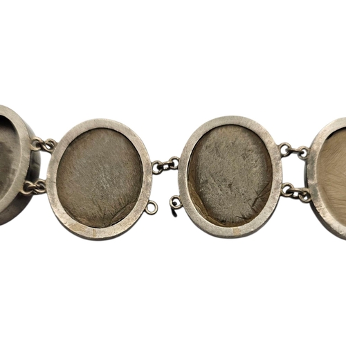 150 - A 19TH CENTURY ITALIAN WHITE METAL AND LAVA CAMEO BRACELET,
Eight carved oval portraits on white met... 