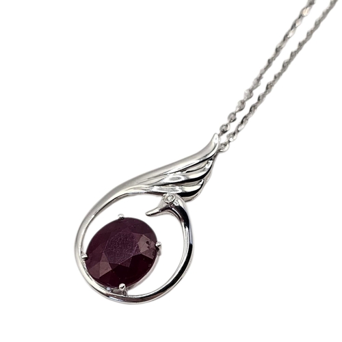 131 - A 14CT WHITE GOLD AND RUBY SWAN PENDANT NECKLACE
The central oval cut ruby set with a single diamond... 