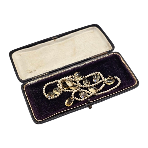 139 - AN EARLY 20TH CENTURY CITRINE AND SEED PEARL NECKLACE
Row of the Elbe oval cut stones on a five seed... 