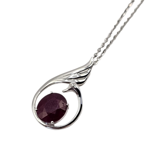 131 - A 14CT WHITE GOLD AND RUBY SWAN PENDANT NECKLACE
The central oval cut ruby set with a single diamond... 