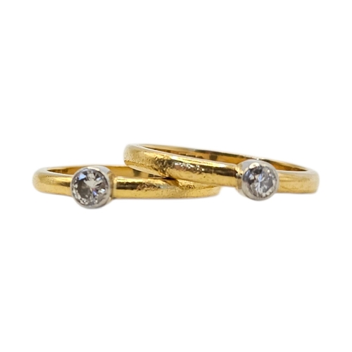 134 - A NEAR PAIR OF VINTAGE 18CT GOLD AND DIAMOND SOLITAIRE RINGS
Plain form, each set with a round cut d... 